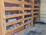 a garage filled with lots of wooden shelves with shoes on them
