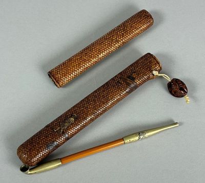 two pens and a pen holder on a table