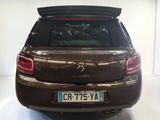 the rear end of a brown car parked in a white room