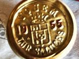 a gold coin sitting on top of a piece of paper