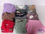 a lot of sweaters that are on a table