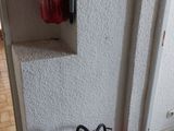 a fire extinguisor on the wall next to a fire hydrant