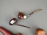 three different types of smoking pipes on the table