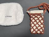 a brown and white bag and a white towel on a table
