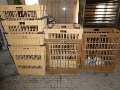 many wooden crates stacked on top of each other on the floor