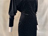 black dress with white polka dots on it on a mannequin mannequin