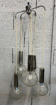 five light bulbs hanging from the ceiling of a room