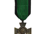 une image représentant une médaille verte et noire ornée d'une croix