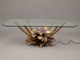 a glass table with a gold flower on it