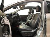the interior of a car with the door open showing the driver ' s seat area