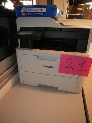 a printer sitting on top of a counter next to a window