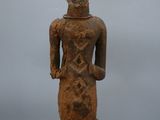 an old wooden statue of a man with a hat on his head