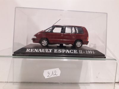 a small red car in a glass display case