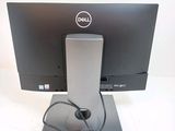 a dell computer monitor with a headset on top of it
