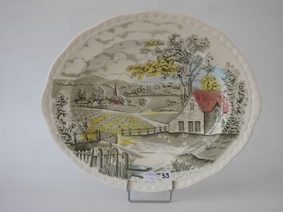 a plate with a picture of a farm scene on it