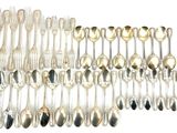 a lot of silver spoons and forks on the table
