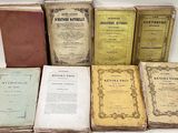 several old books sitting on top of each other on a table