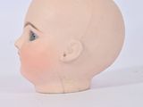 a small doll head and a small doll head on a table