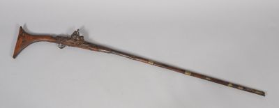 a wooden stick with a long handle on a white surface
