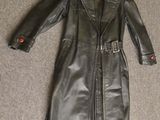 black leather trench coat with red buttons on a hanger