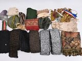 many different types of scarves laid out on a table