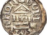 a silver coin with a small house on top of it