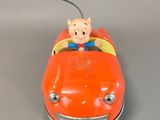 an orange toy car with a pig on top of it
