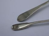 two spoons and a fork on a table