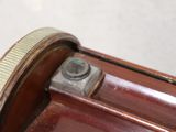 a close up of a piece of wood with a nut on it