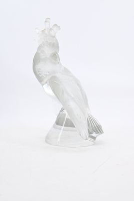 clear glass figurine of a bird on a clear base