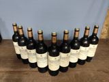 six bottles of wine are lined up in a row on a table