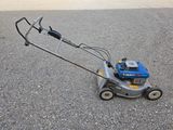 an image of a lawn mower sitting on the ground