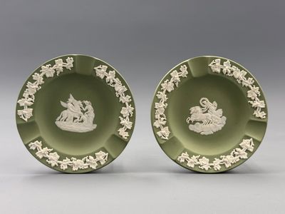 pair of green and white plates with figures on them