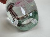 a person holding a glass object with a jelly inside of it