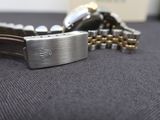 a watch that is laying on a table with a chain around it