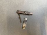a knife and a pocket knife sitting on a table
