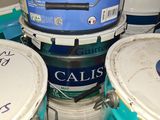 several buckets of paint are stacked on top of each other