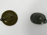 two metal buttons that are on a white surface