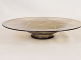 a glass plate with a design on it sitting on a table
