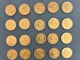a close up of a bunch of gold coins on a table