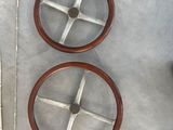 two wooden wheels on the side of a boat