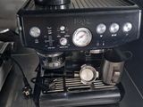 a black coffee machine sitting on a counter in a kitchen