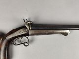 a close up of a gun that is on a white surface