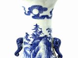 a blue and white vase with a picture of elephants on it