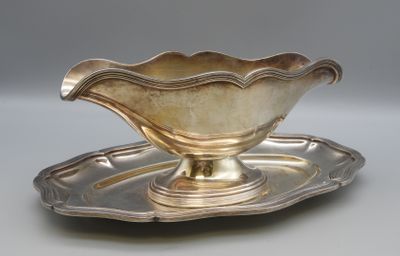 a silver plate with a silver saucer on it