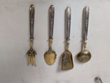 five spoons and two spoons hanging on a wall