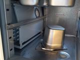a small oven with a pot inside of it