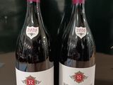 deux bouteilles de vin rouge posées sur une table