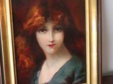 painting of a woman with red hair in a gold frame
