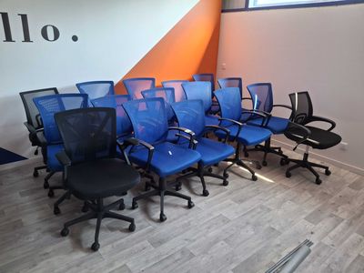 a lot of blue chairs in a room with orange walls